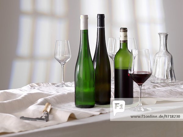 Rotweinglas  Weinflaschen und leere Gläser