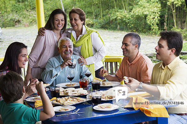 Hispanic family enjoying meal together
