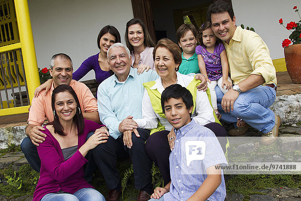 Hispanic family sitting on steps together