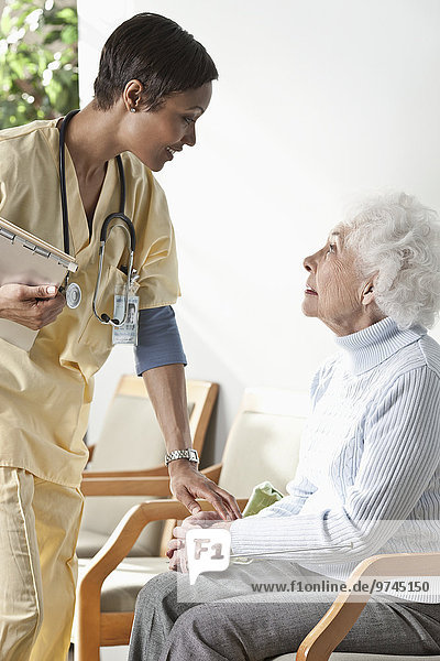 Nurse talking to elderly woman
