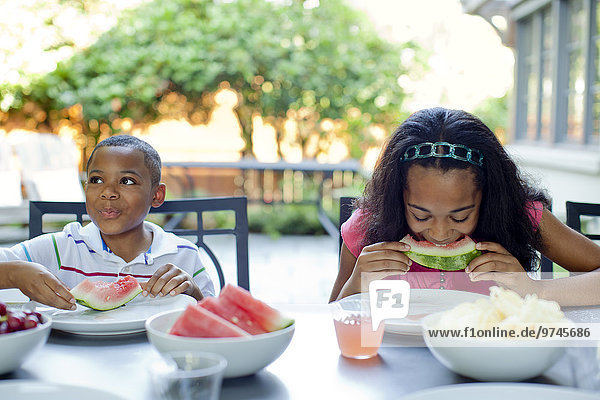 African American children eating lunch on patio