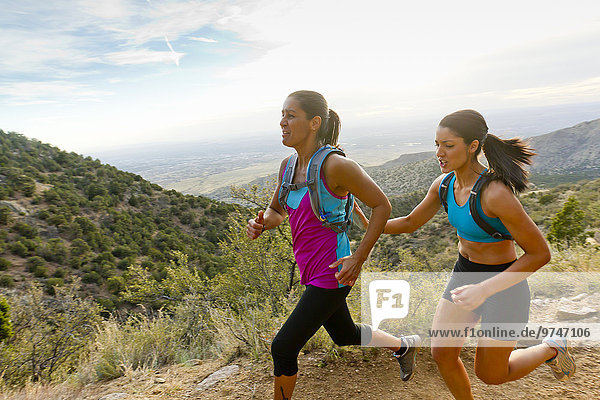 Hispanic women running in remote area