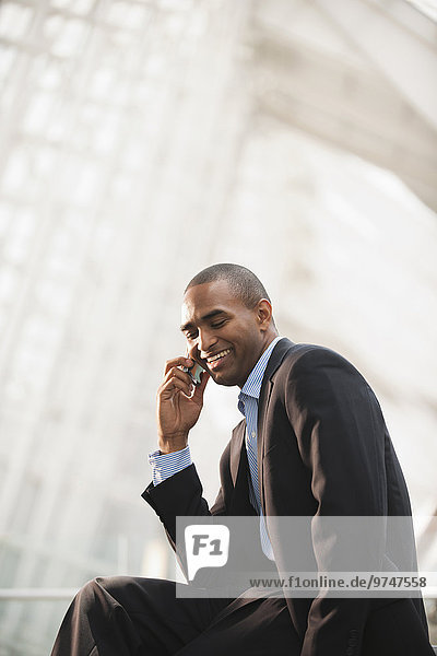 Black businessman talking on cell phone