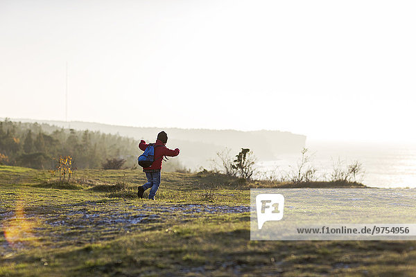 Boy running on meadow