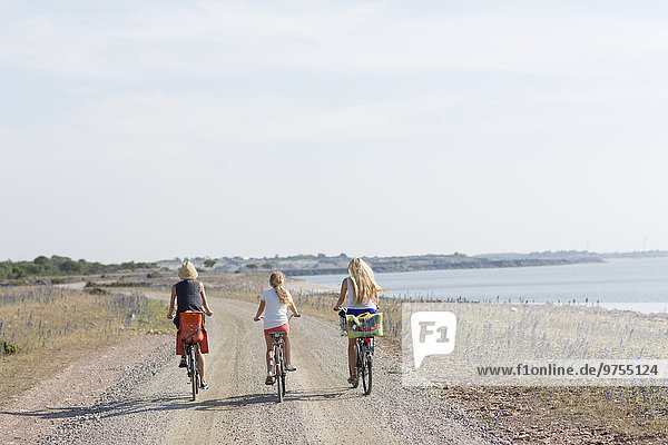 Mother with two daughters cycling