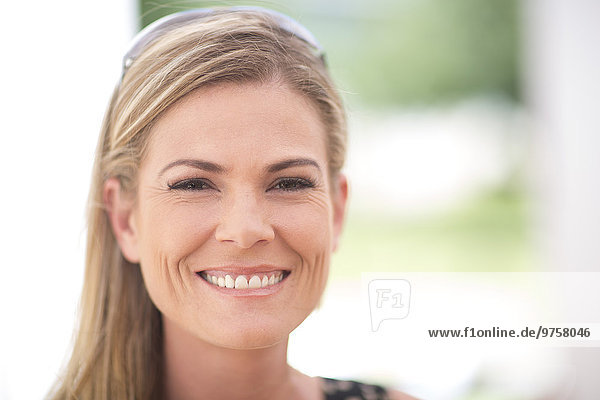 Portrait of smiling blond woman outdoors