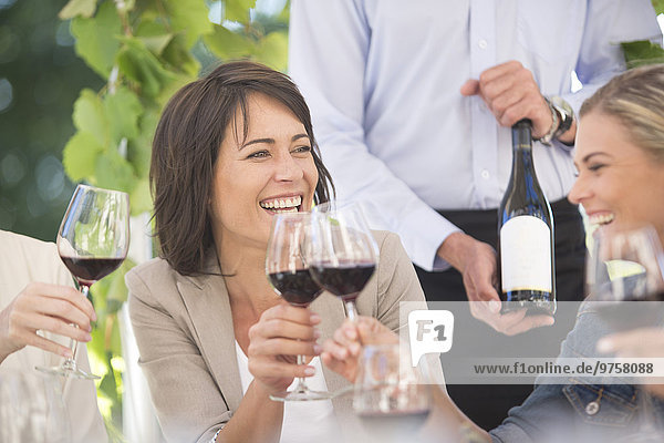 Women enjoying wine tasting session with red wine
