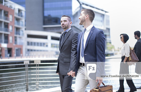 Gay couple travelling with business suits