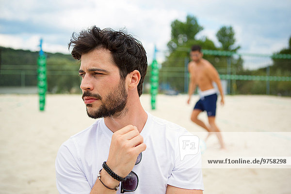 Young man on beach volleyball field