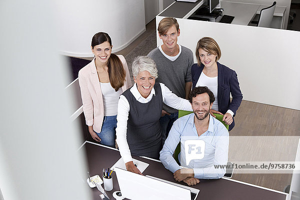 Happy business team at desk in office