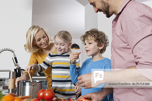 Family cooking in kitchen