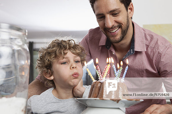 Father and son with birthday cake