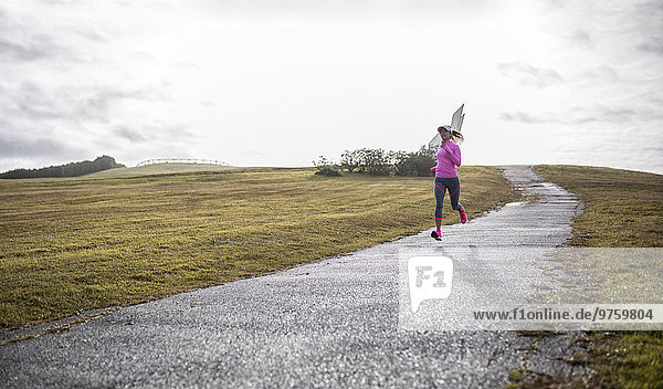 Spain  Gijon  sportive young woman running on path