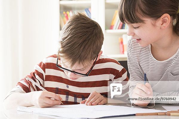 Brother and sister drawing together