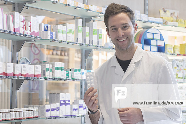 Portrait of smiling pharmacist in pharmacy