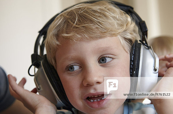 Little boy listening to music with headphones