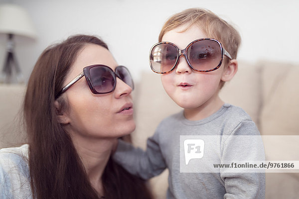 Mother and little son wearing sunglasses