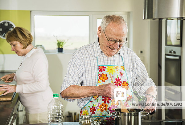 Senior couple cooking in kitchen