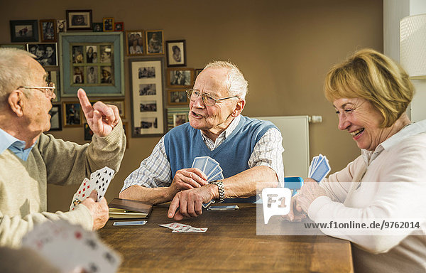 Senior friends playing cards