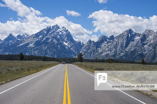 Road leading in the Teton range in the Grand Teton National Park  Wyoming  United States of America  North America