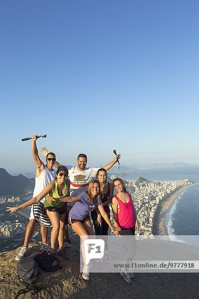 Local tourists on the summit of Dois Irmaos peak (Two Brothers Peak) with Ipanema  Corcovado and Rio city below  Rio de Janeiro  Brazil  South America