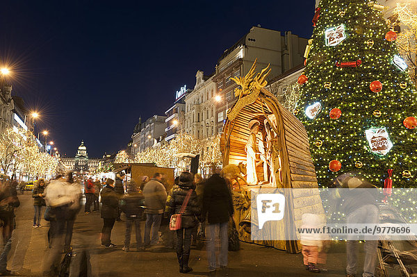 Christmas Market and Christmas tree  Nativity Scene and National Museum at Wenceslas Square during Advent evening  Nove Mesto  Prague  Czech Republic  Europe