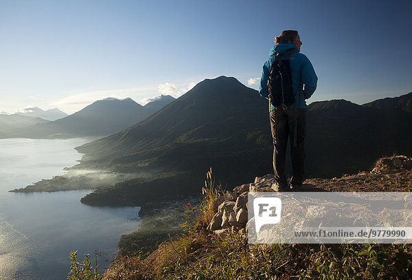 Woman enjoying the view from the Indian Nose lookout  Lago Atitlan  Guatemala  Central America