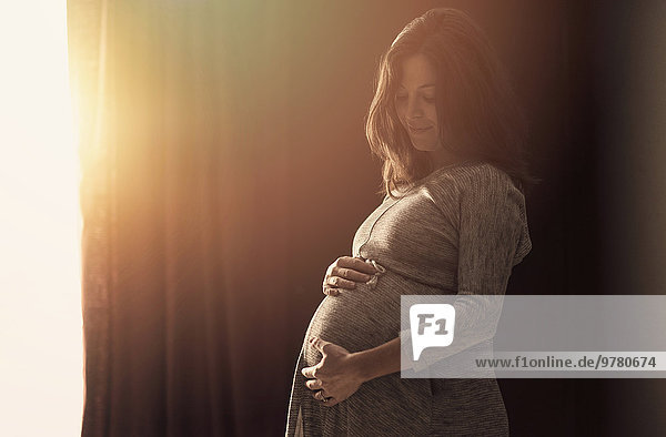 Interior zu Hause Frau berühren Schwangerschaft