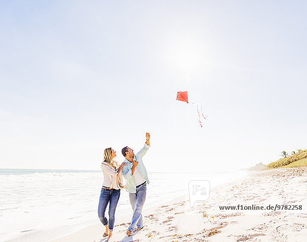Couple on beach with kite