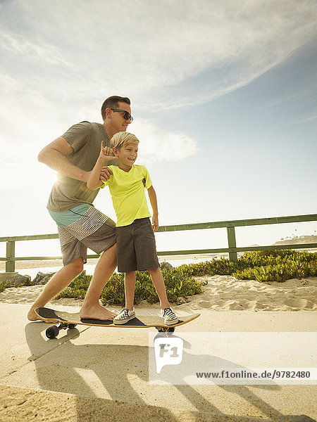 Father skateboarding with his son (6-7)