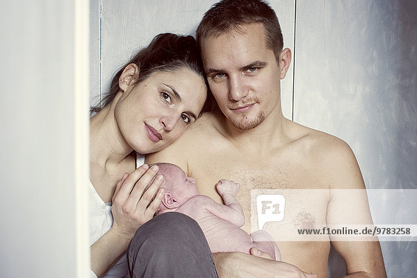 Parents holding newborn baby  portrait
