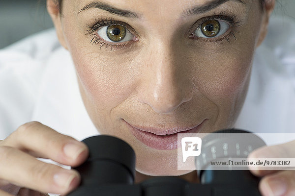 Scientist using microscope  portrait
