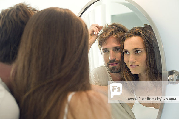 Woman suggesting husband needs haircut