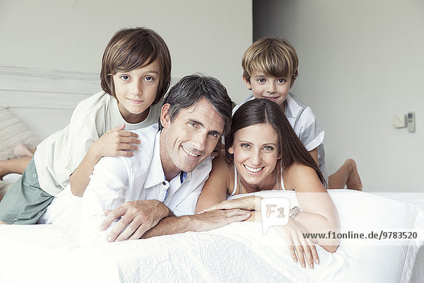 Family lying on bed  portrait