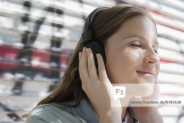 Close up of Caucasian woman listening to headphones
