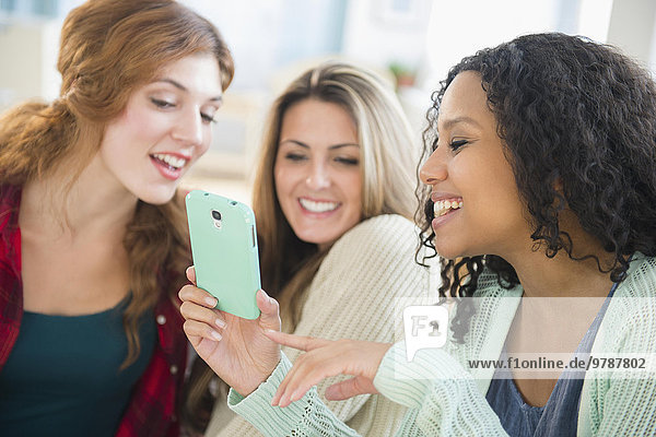 Close up of women using cell phone