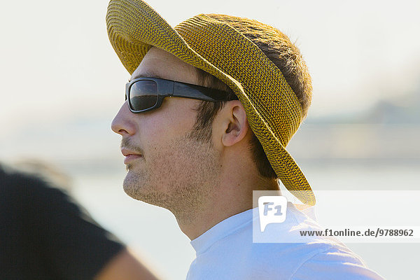 Caucasian man wearing sun hat and sunglasses