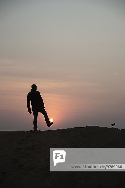 Man silhouetted against sunrise  Chintsa  South Africa  Africa