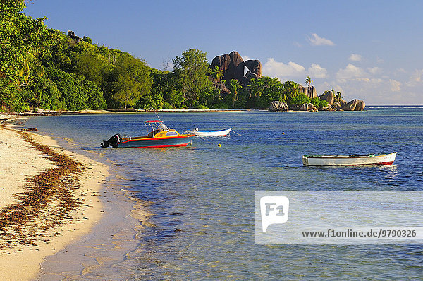 Boats in shallow water at the beach Anse la Réunion La Digue Seychelles Africa