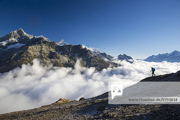 Hiker on the trail to the Hörnli hut  Zermatt  Canton of Valais  Switzerland  Europe