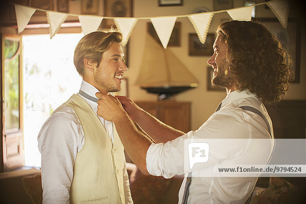 Bridegroom and best man preparing for wedding ceremony