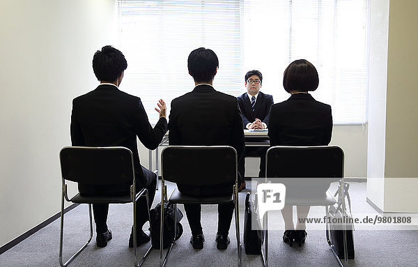 Young Japanese business people work examination