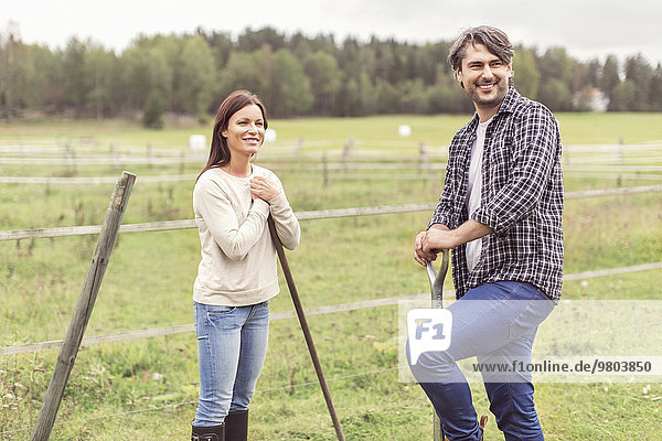 Happy mid adult couple working in organic farm