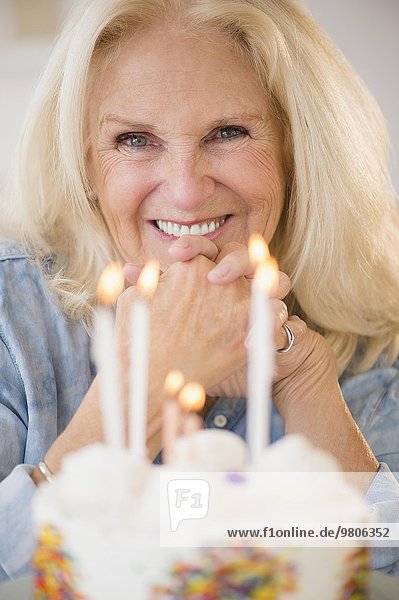 Portrait of senior woman with birthday cake