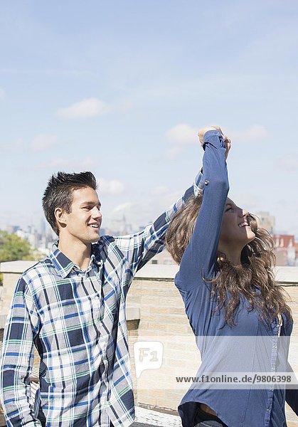 Young couple dancing on roof