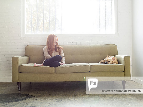 Woman and pug on sofa
