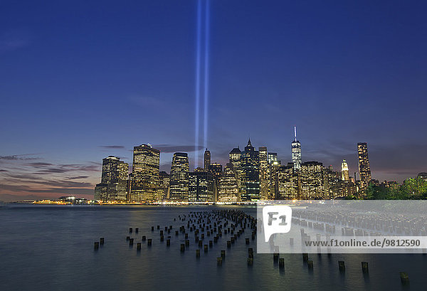 Night view of light beams over Lower Manhattan from Brooklyn Heights Promenade  New York  USA