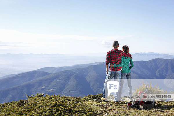 Hikers enjoying view from hilltop  Montseny  Barcelona  Catalonia  Spain