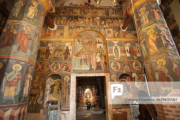 Doorway and columns in orthodox church with romanesque frescoes  Bucharest  Romania