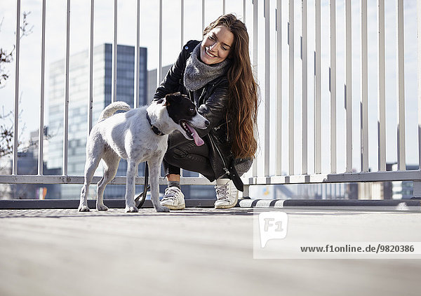 Deutschland,  Düsseldorf,  Junge Frau geht mit ihrem Hund spazieren
